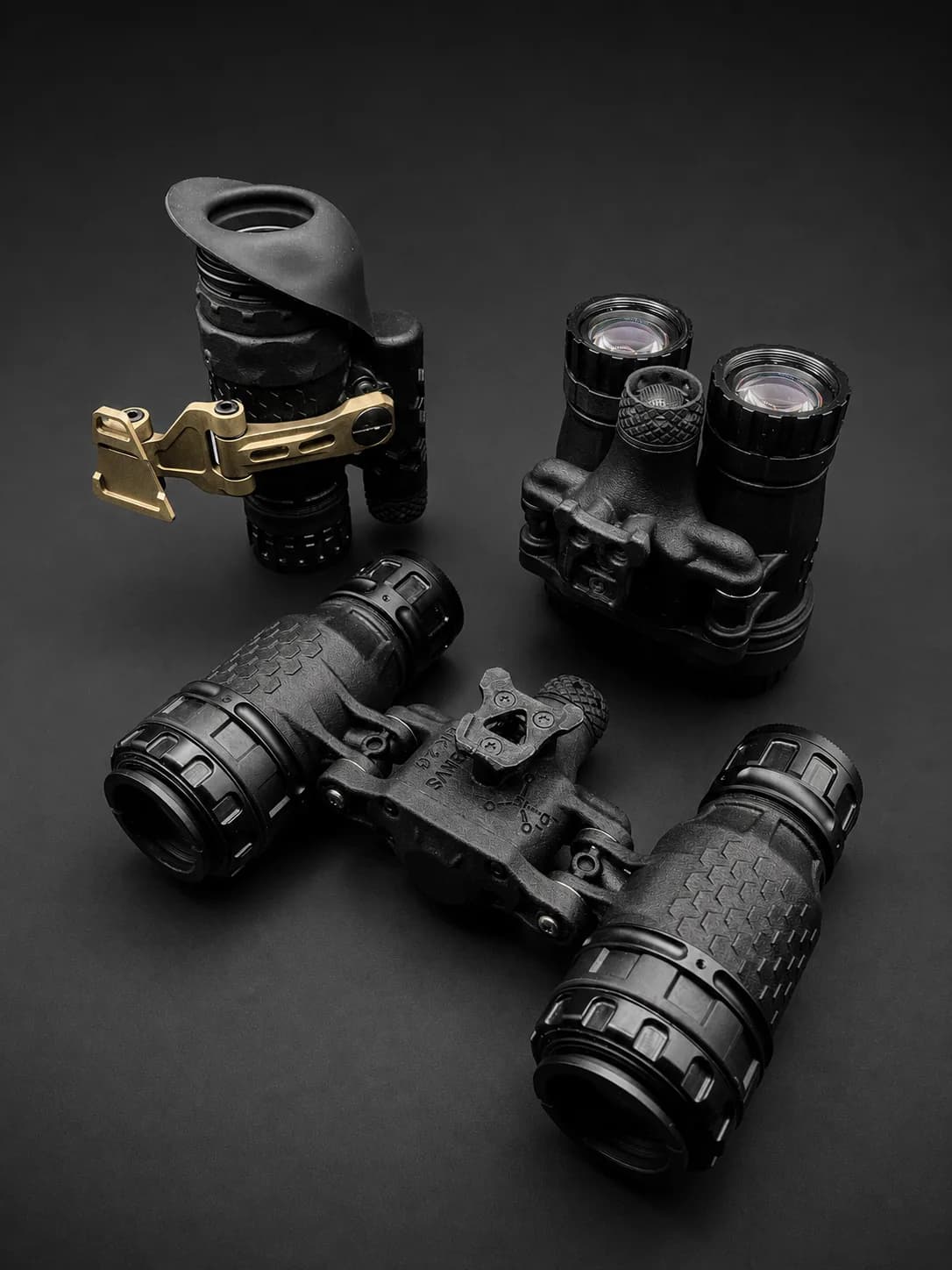 LNVM monocular and LAB-NVS MK2 binocular with their accessories, dark background